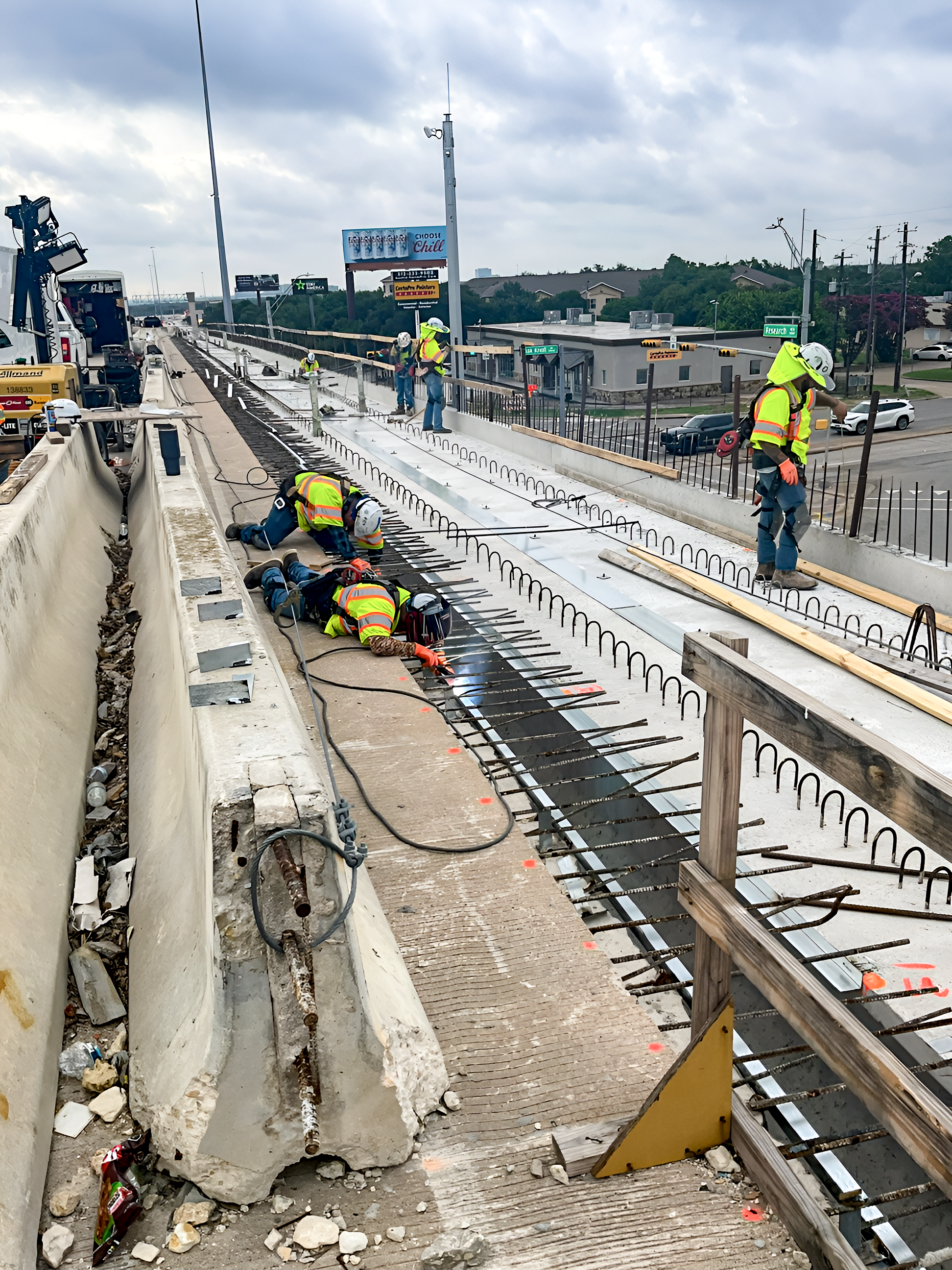 Wide shot of 6 workers placing rebar to reinforced concrete work